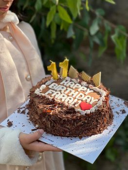 A delicious chocolate birthday cake with candles for an 11th birthday celebration.