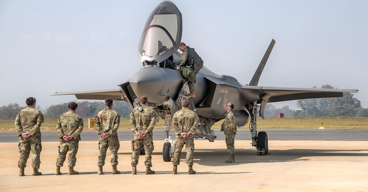 Soldiers observing a fighter jet at an air show in Bengaluru, India.
