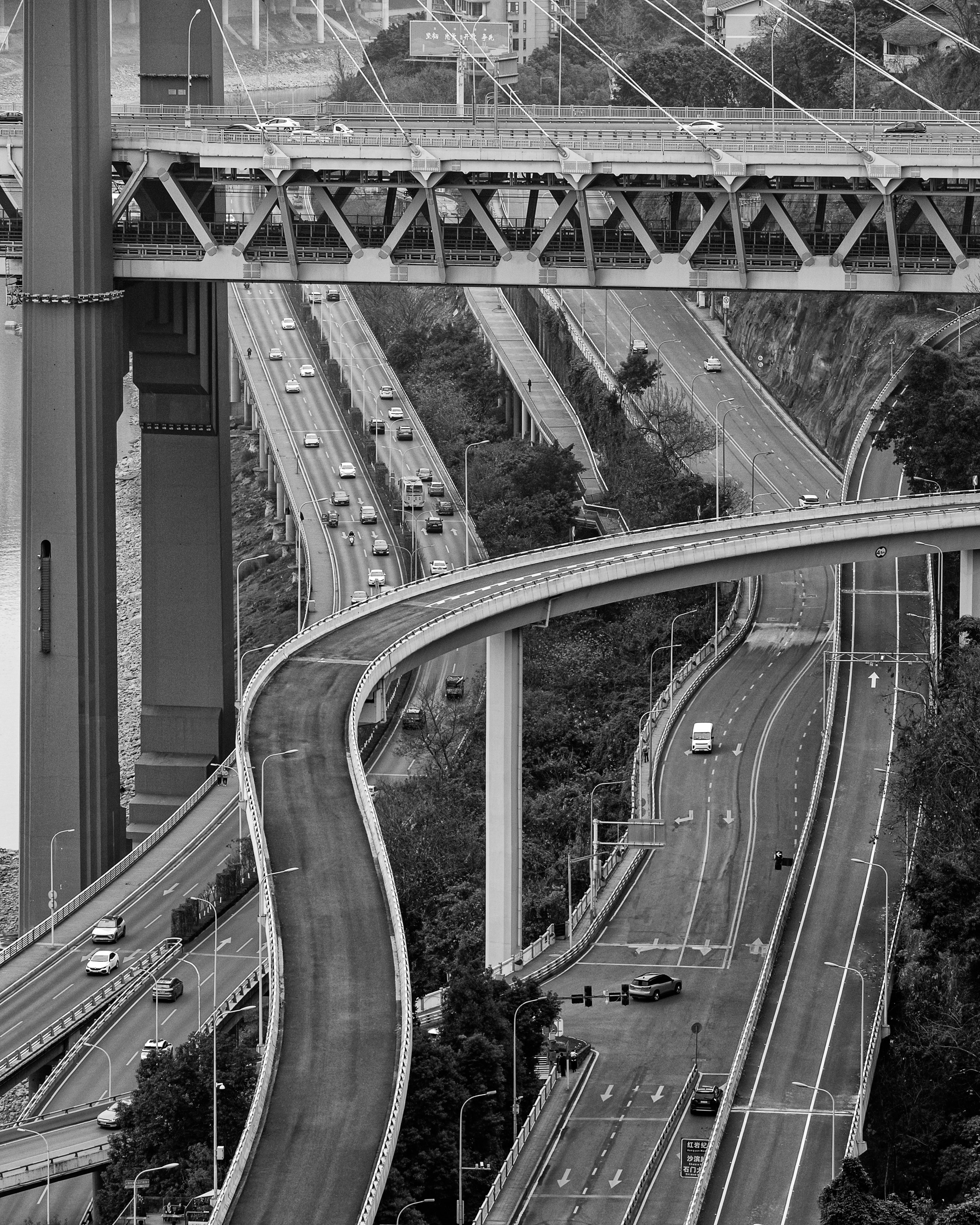 Dynamic aerial view of a highway interchange captured in monochrome, showcasing urban infrastructure.