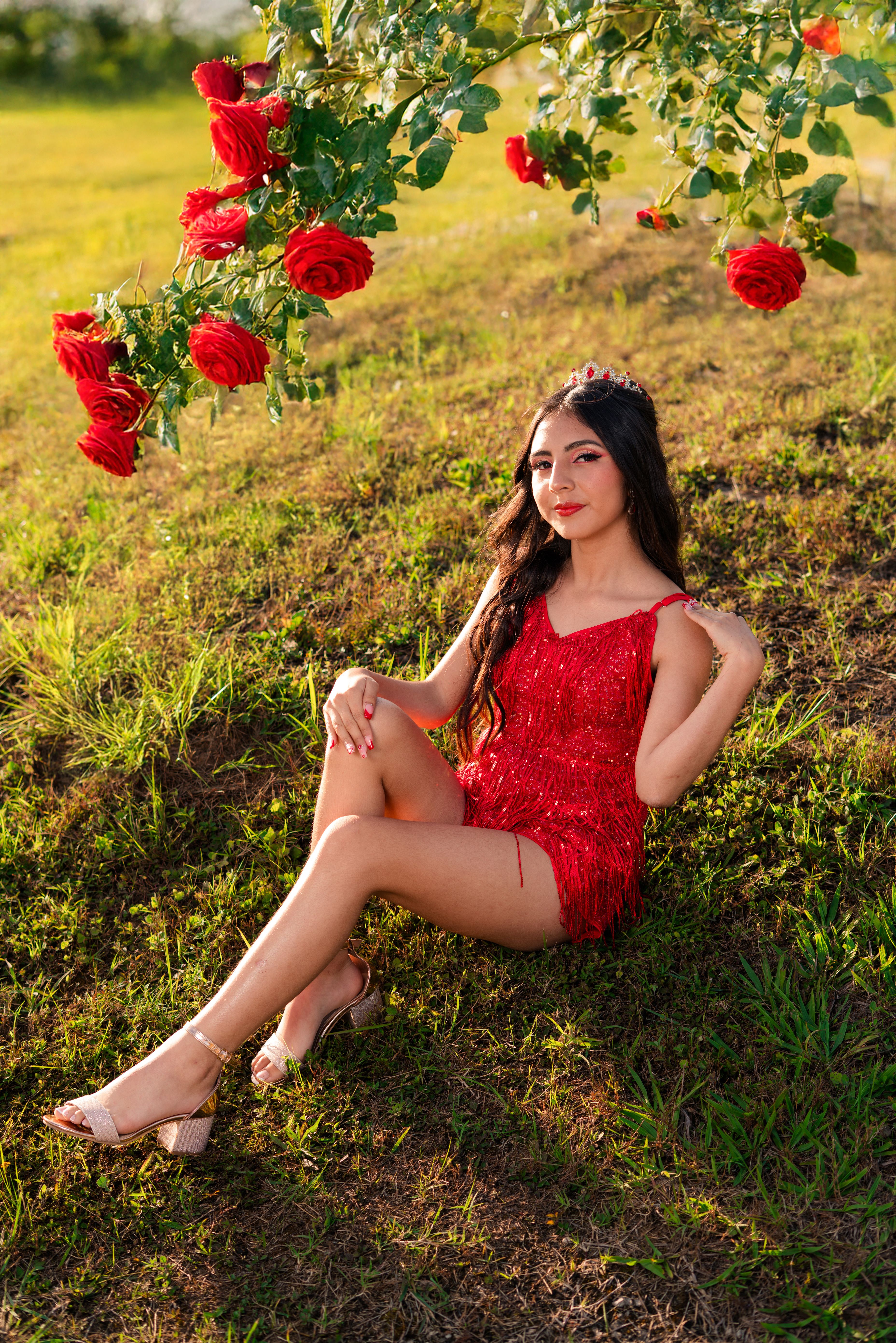 Elegant Woman in Red Dress with Roses Outdoors · Free Stock Photo