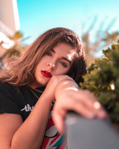 Woman Leaning Near Plants