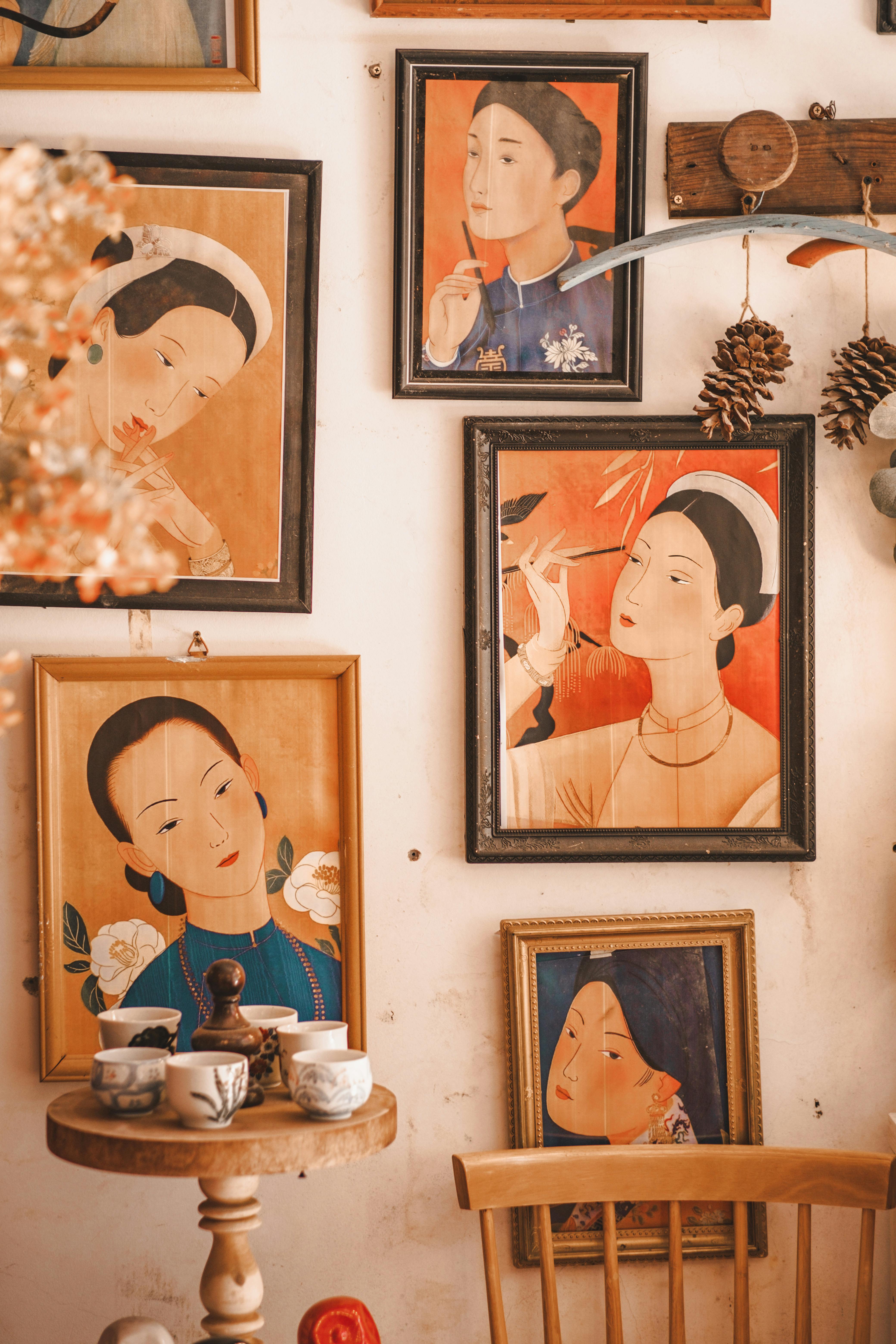 Cozy room with vintage framed portraits and rustic decorations on the wall.