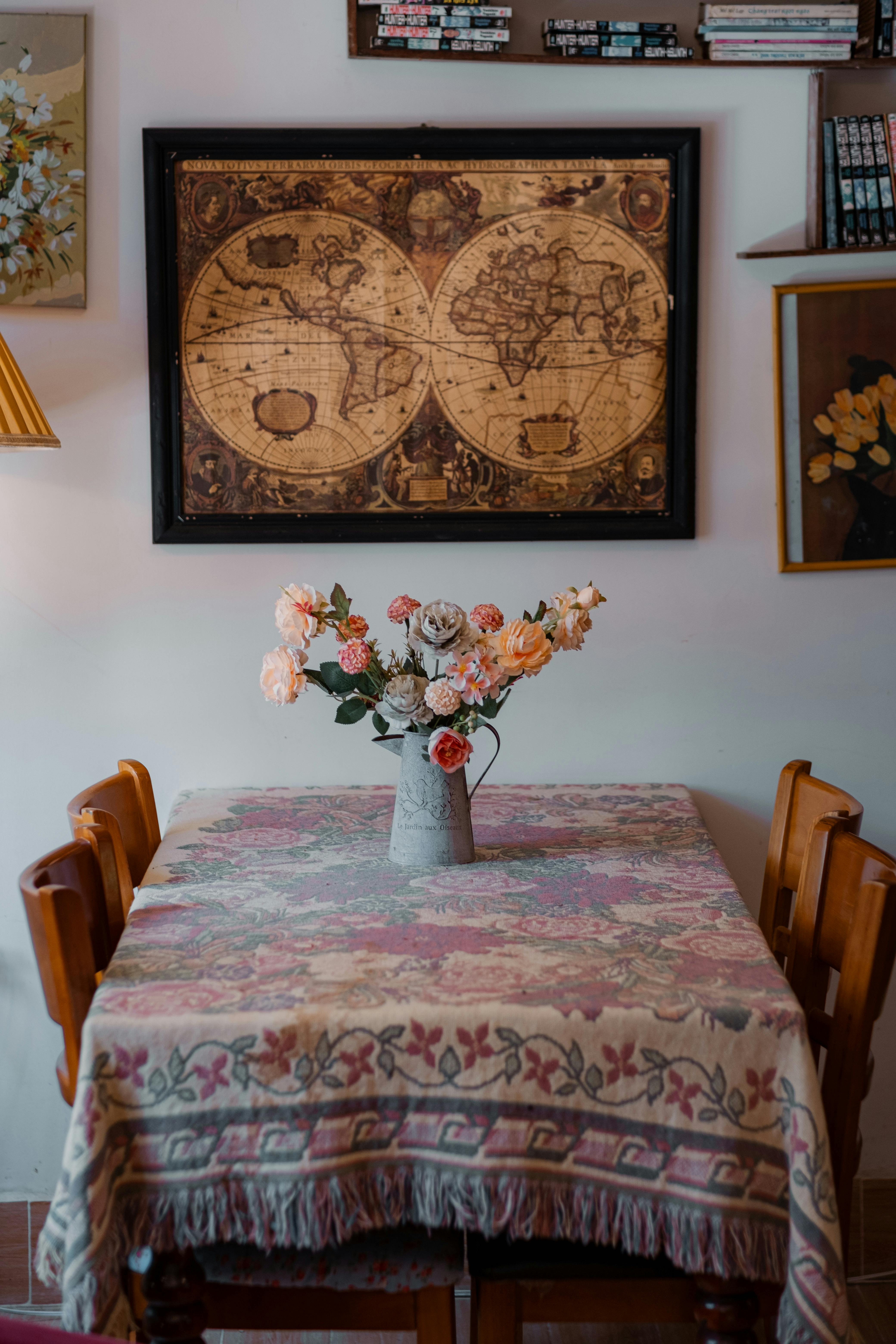 Cozy dining room featuring a vintage map and floral arrangement.