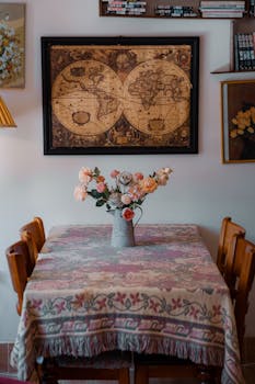 Cozy dining room featuring a vintage map and floral arrangement.