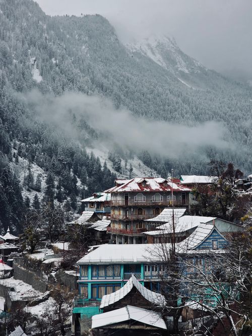 Free Charming snow-covered village nestled in the Himalayan mountains of Himachal Pradesh, India. Stock Photo