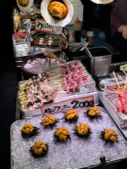 Colorful street food stall in Osaka with fresh sea urchins and skewers on ice.