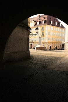 A scenic street view in Görlitz, Saxony, Germany, featuring classic architecture under an archway.