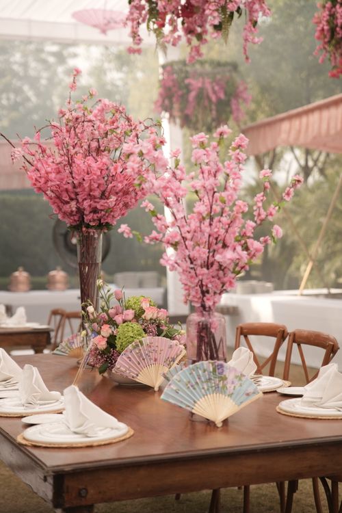 Free Charming outdoor wedding table in Udaipur decorated with pink flowers and elegant tableware, perfect for a destination event. Stock Photo