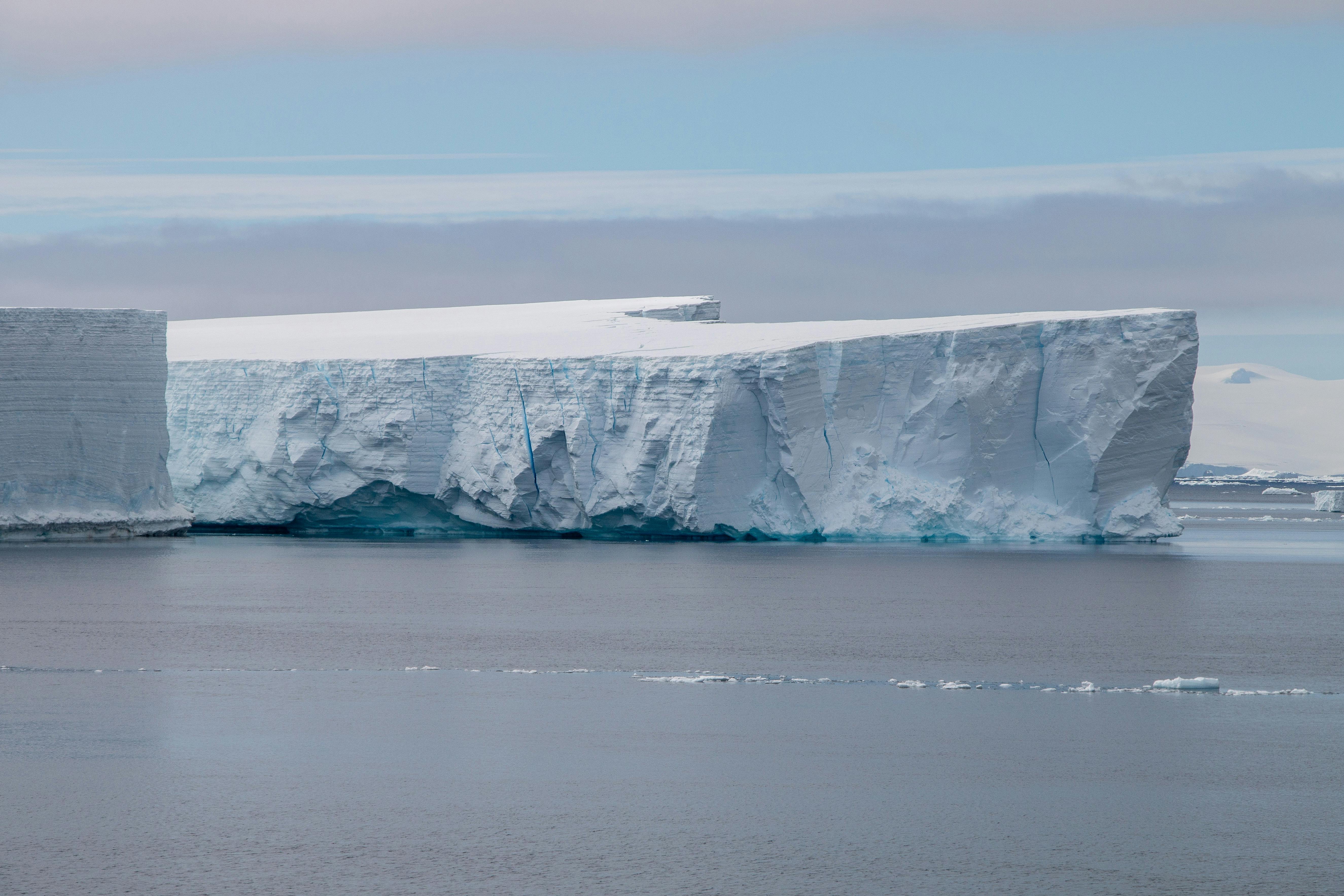 Antarctic landscape with ice, glacier and calm sea in daylight