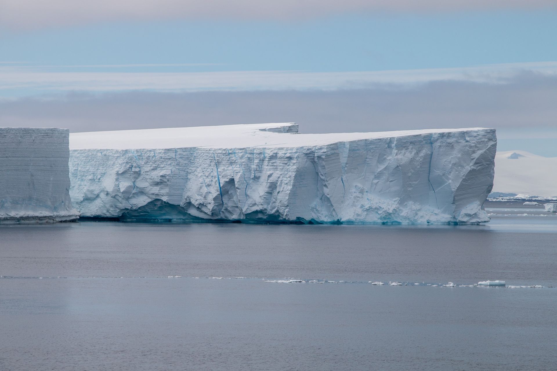 Antarctic landscape with ice, glacier and calm sea in daylight