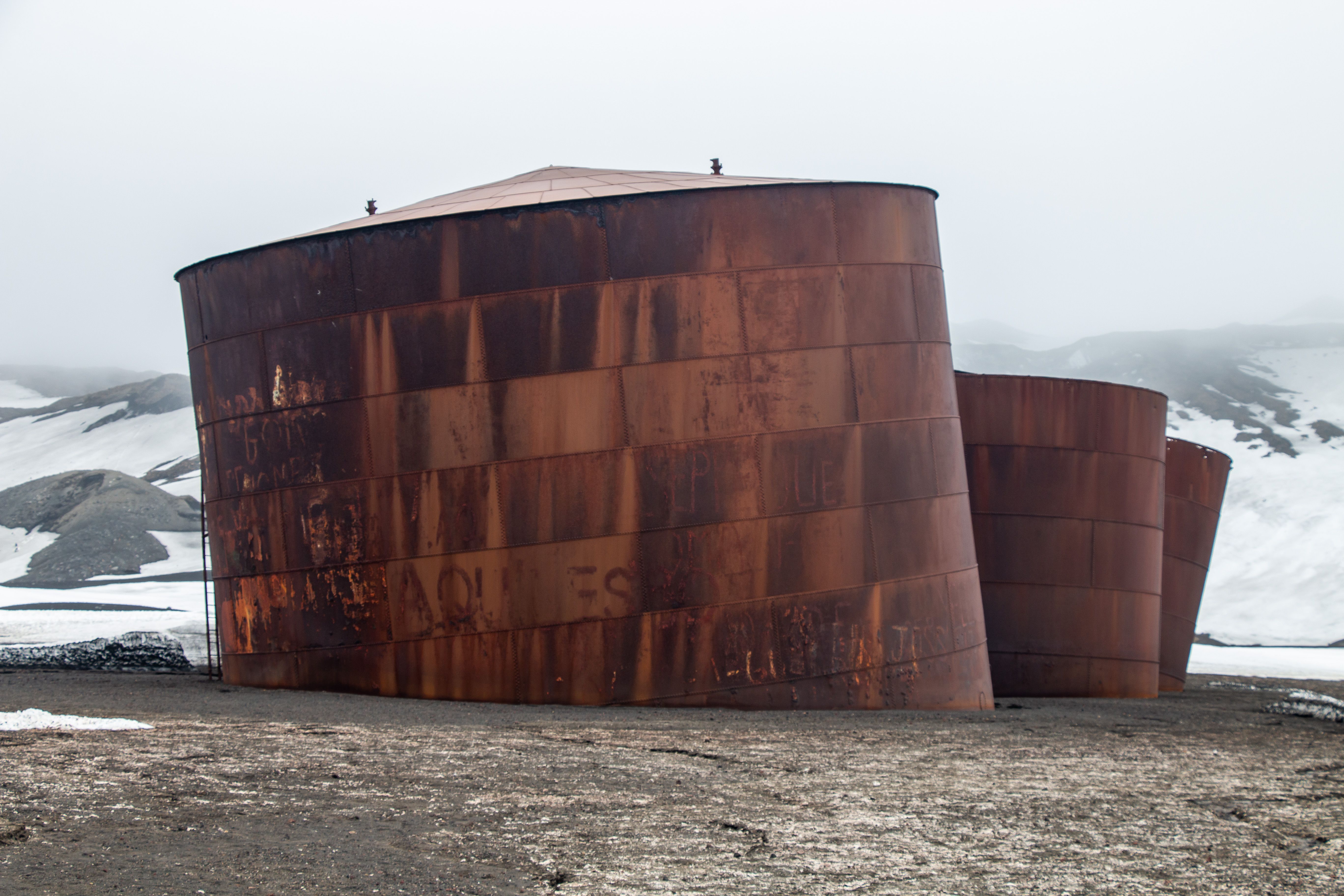 Rusty Tanks in Antarctic Landscape · Free Stock Photo