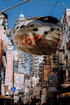 Dynamic street view of Shinsekai, Osaka, showcasing lively signs and architecture.
