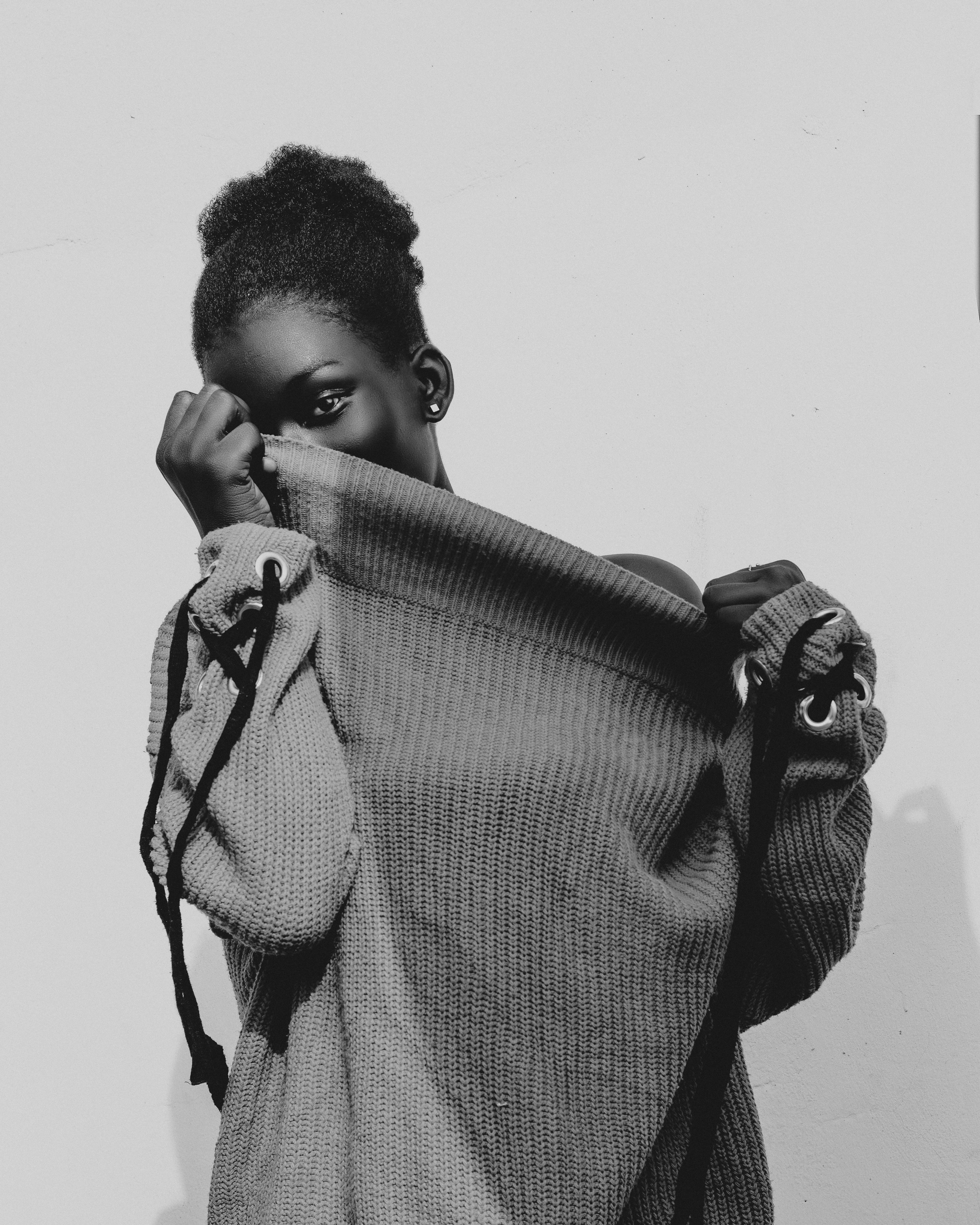 Black and white portrait of a woman in street fashion, exuding elegance and style.