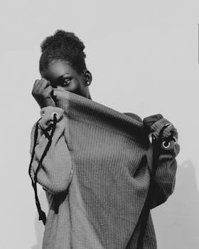Black and white portrait of a woman in street fashion, exuding elegance and style.