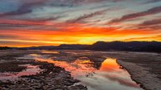 Stunning sunset reflecting in the river at Alma, Wisconsin, with vibrant skies.
