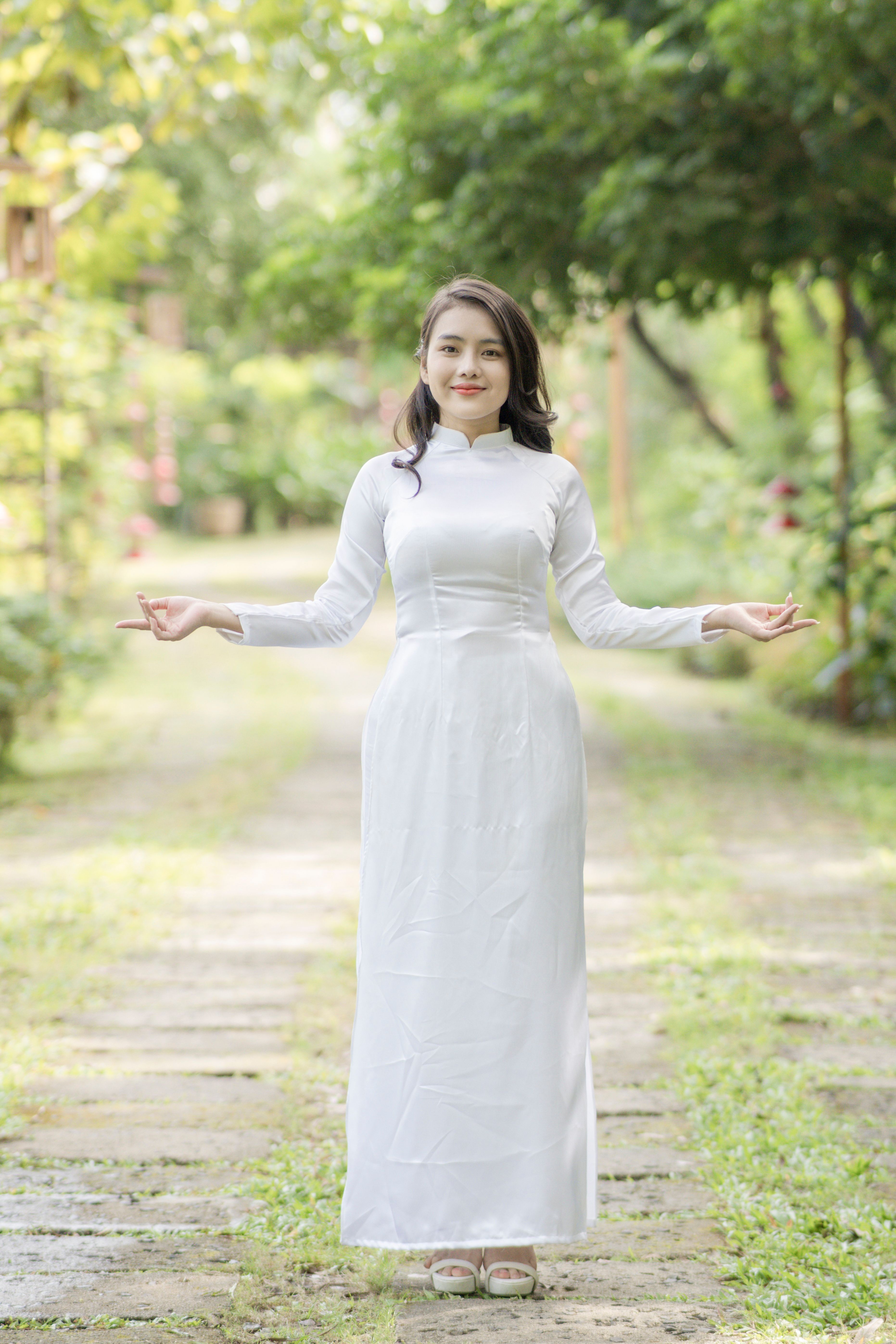 Young woman in traditional white dress outdoors · Free Stock Photo