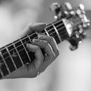 Close-Up of Hand Playing Guitar in Black and White
