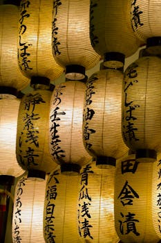 A collection of traditional Japanese paper lanterns glowing warmly at night.