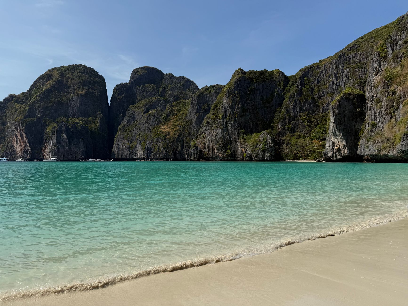 Stunning view of Maya Bay with turquoise waters and limestone cliffs in Thailand.
