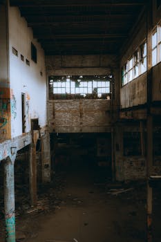 Explore the haunting atmosphere of an abandoned warehouse interior, rich with urban decay.