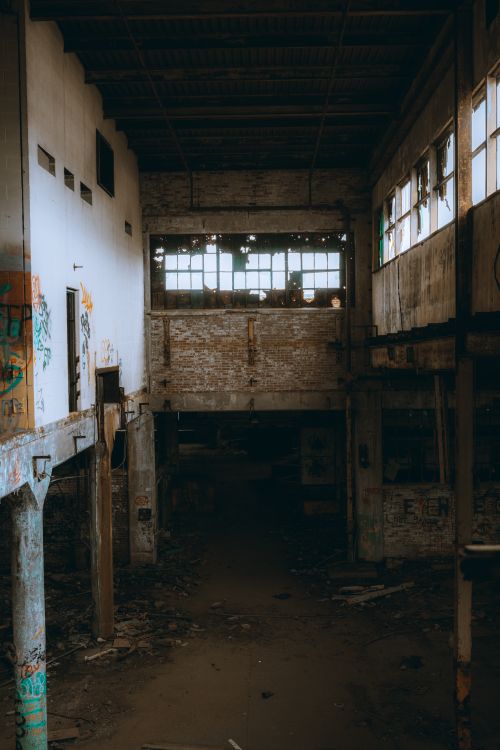 Free Explore the haunting atmosphere of an abandoned warehouse interior, rich with urban decay. Stock Photo