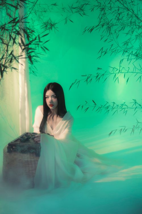 Free Enchanting scene of a woman in a bamboo grove with a mysterious atmosphere. Stock Photo