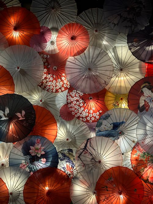 Free Vibrant paper umbrellas overlapping in a stunning night display, showcasing traditional Vietnamese artistry. Stock Photo