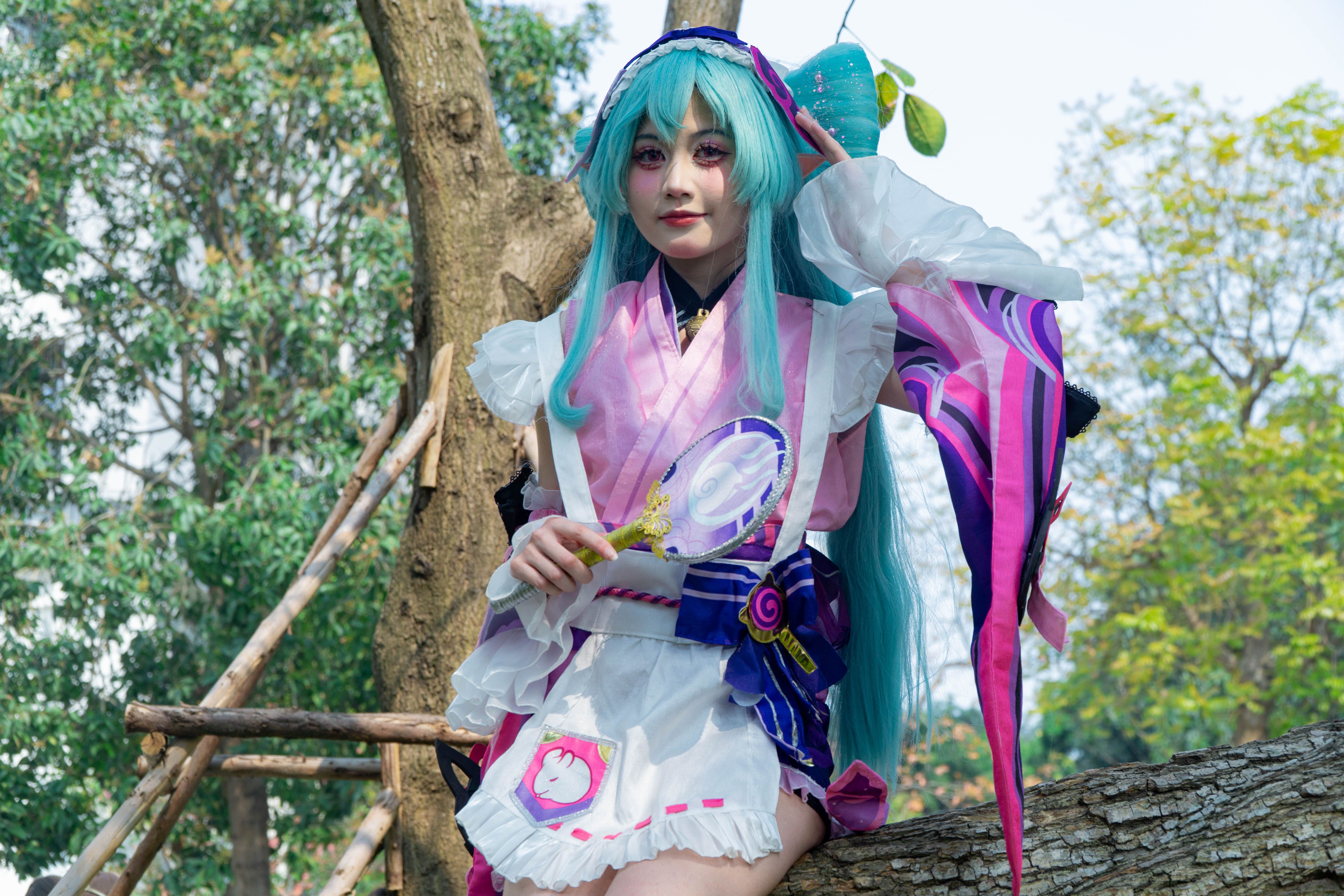 Cosplayer in Vibrant Costume with Long Teal Hair Outdoors