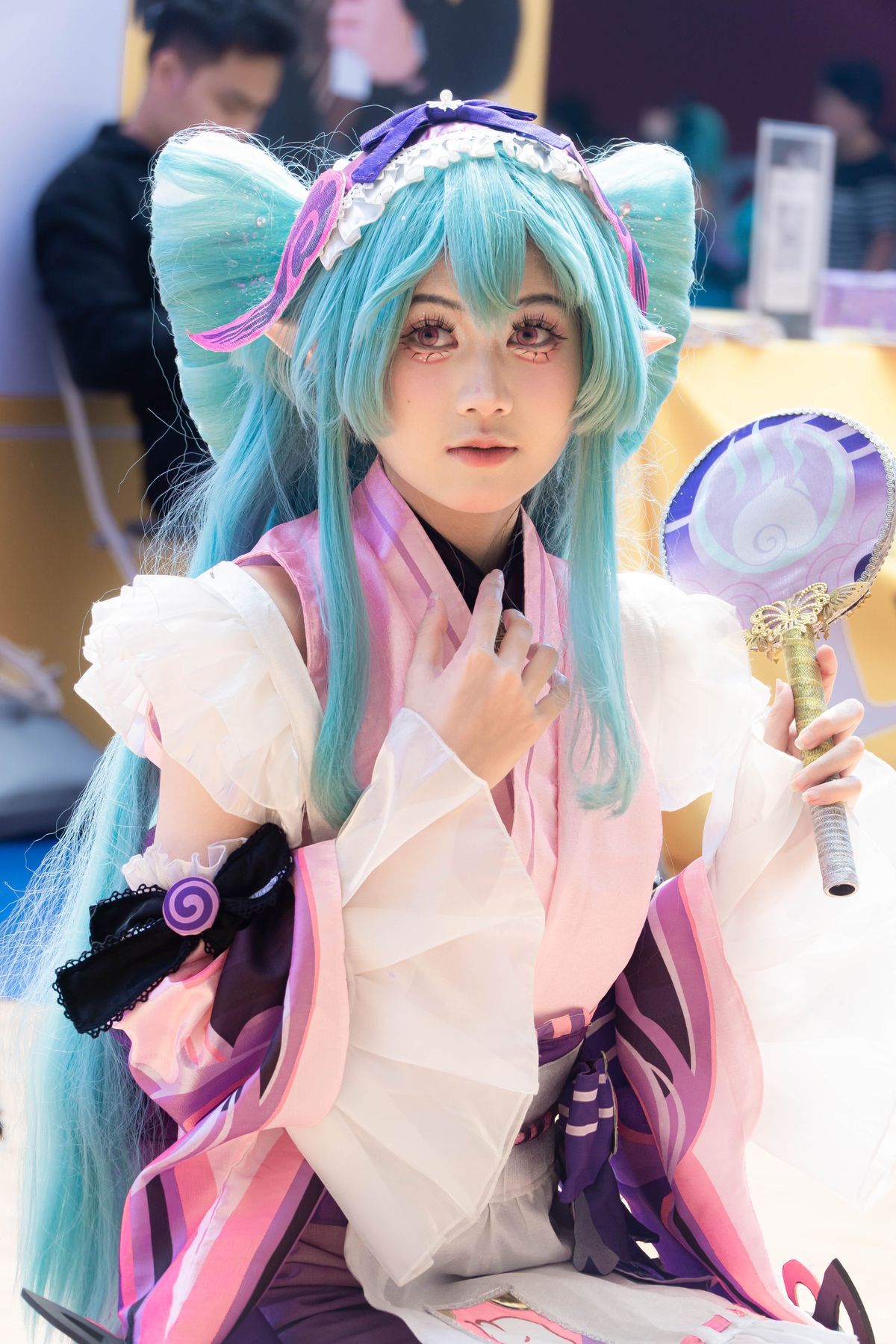 Cosplayer with teal fantasy wig and coordinated look