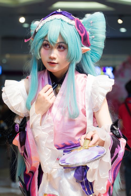 Free Vivid anime cosplay with pastel hues at indoor anime convention. Stock Photo