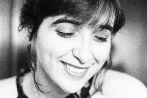 Free Captivating black and white close-up portrait of a smiling woman with a serene expression. Stock Photo