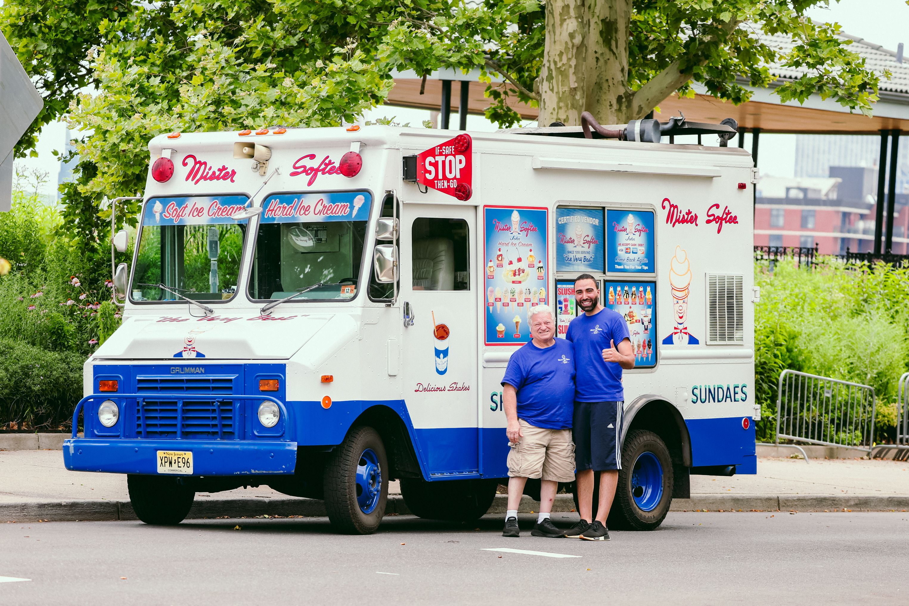 Mister Softee ice cream truck parked in Hoboken, New Jersey with two smiling men.