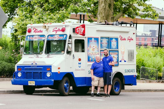 Mister Softee ice cream truck parked in Hoboken, New Jersey with two smiling men.