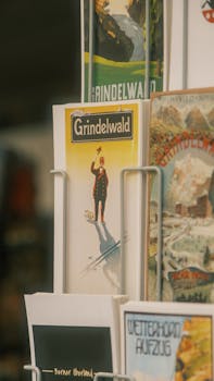 Vintage postcards of Grindelwald displayed in a rack, showcasing classic designs.
