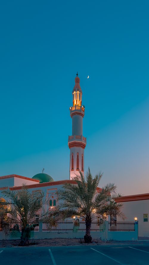 Free Beautiful mosque exterior with minaret set against a twilight sky in Dubai. Stock Photo