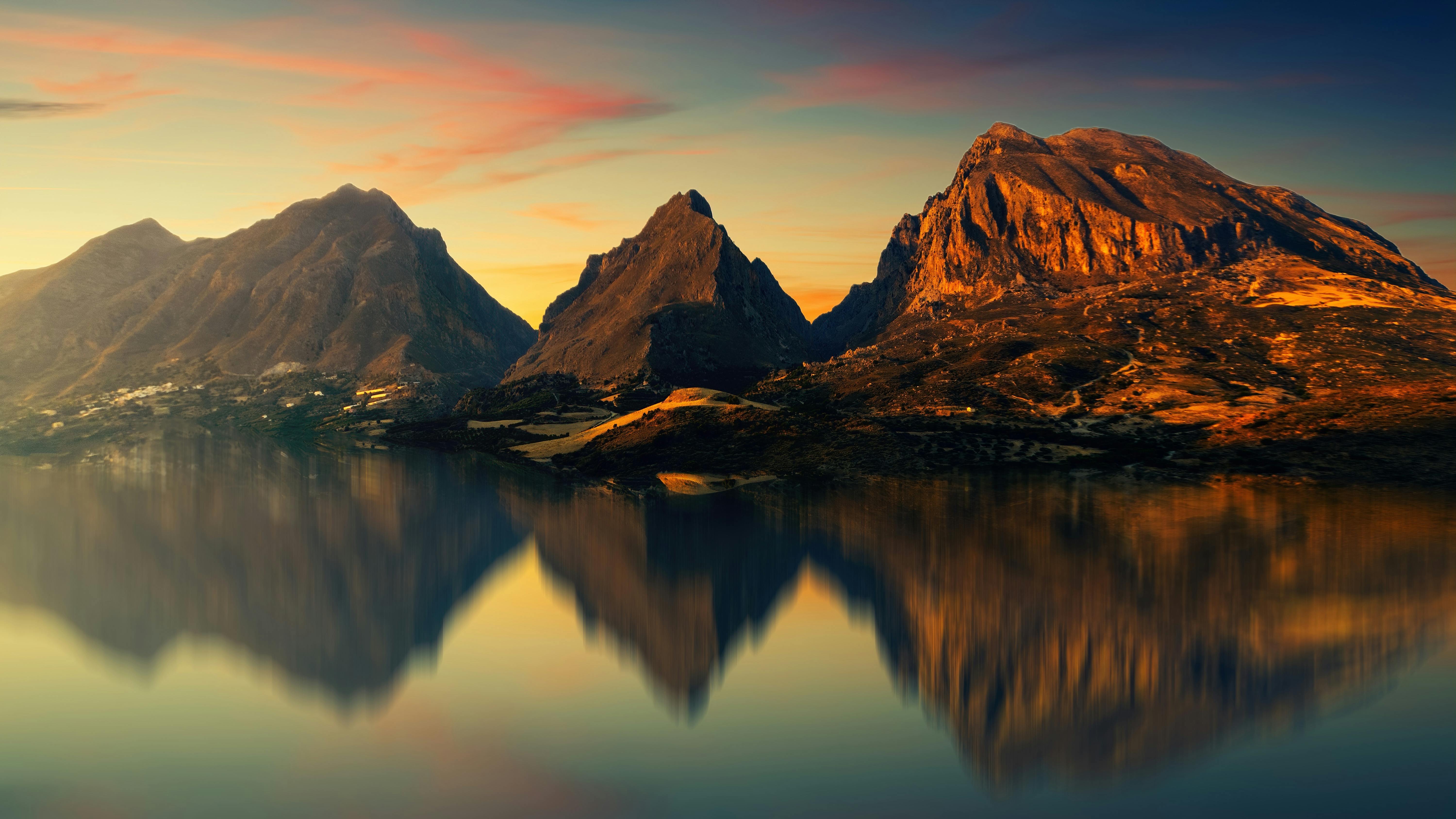 brown mountain near body of water