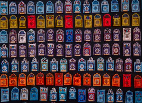 Vibrant Moroccan tiles arranged in an artistic wall display showcasing intricate designs.