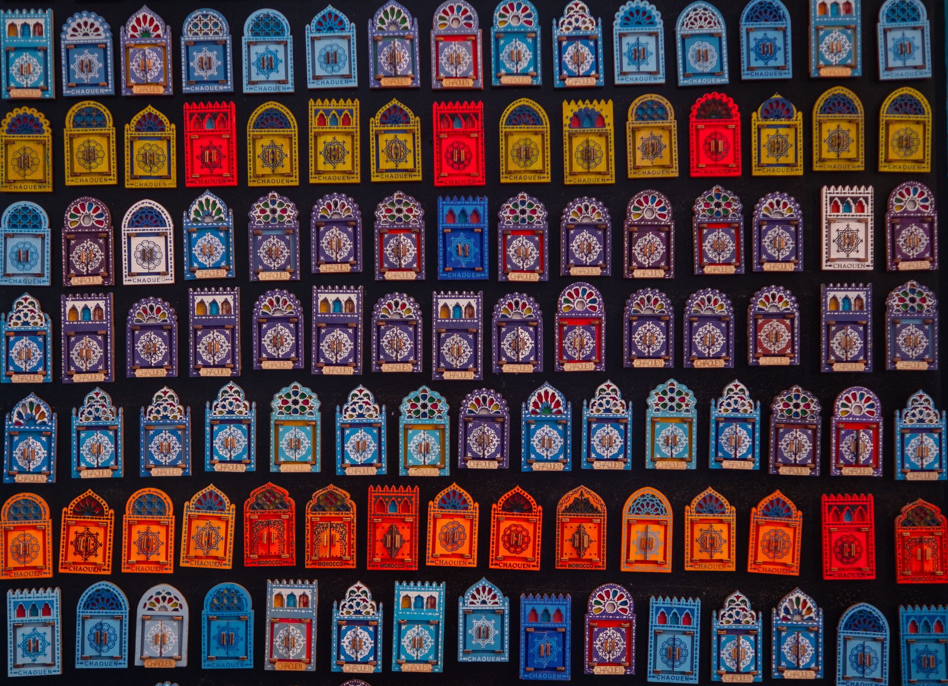 Vibrant Moroccan tiles arranged in an artistic wall display showcasing intricate designs.