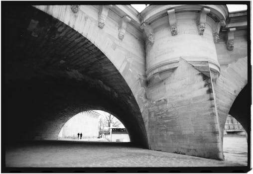 Atmospheric shot of a bridge arch in Paris, showcasing stunning architectural details.
