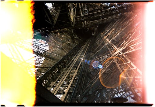 A captivating upward view of the Eiffel Tower's complex interior framework in Paris, France.