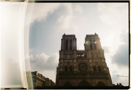 Notre Dame Cathedral silhouette with dramatic sunset sky in Paris, France.
