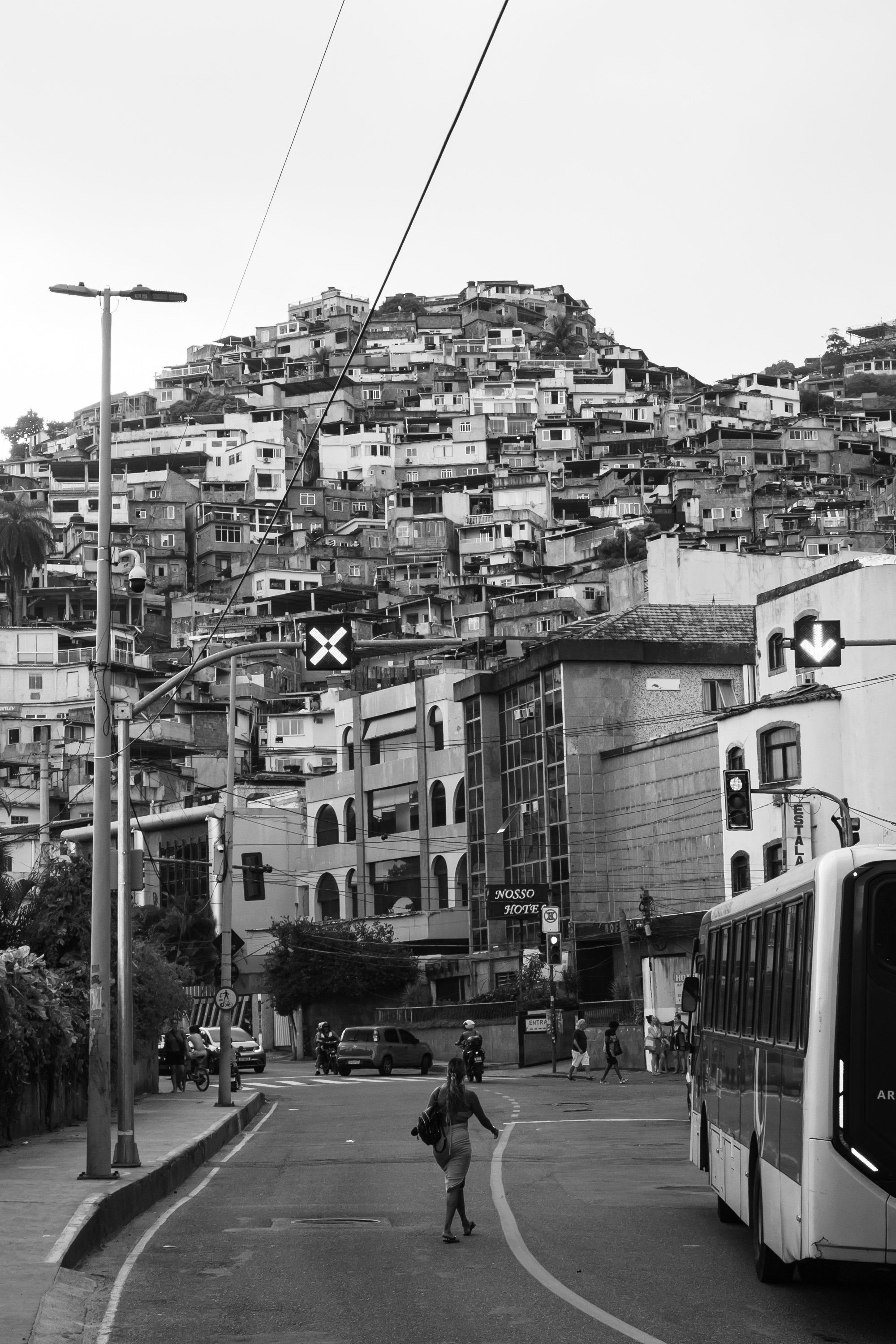 B&W cityscape of favela on hilltop, capturing urban life dynamics.