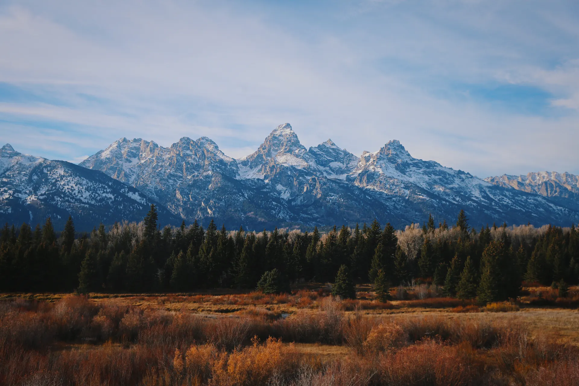 Landscape featuring the Grand Teton mountains under a clear sky. Landscape featuring the Grand Teton mountains under a clear sky.