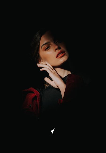 A captivating portrait of a woman partially lit, conveying mystery and beauty.