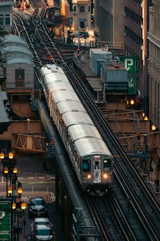 Captivating view of a train navigating through the elevated tracks in a bustling urban setting.