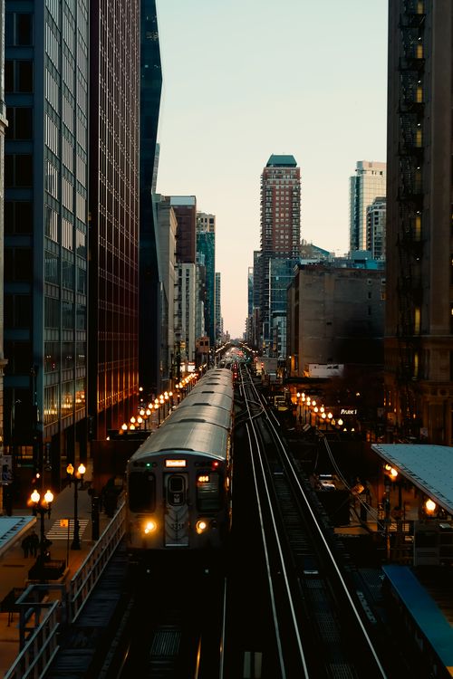 Free Dusk view of a train navigating through the high-rise buildings of downtown Chicago. Stock Photo