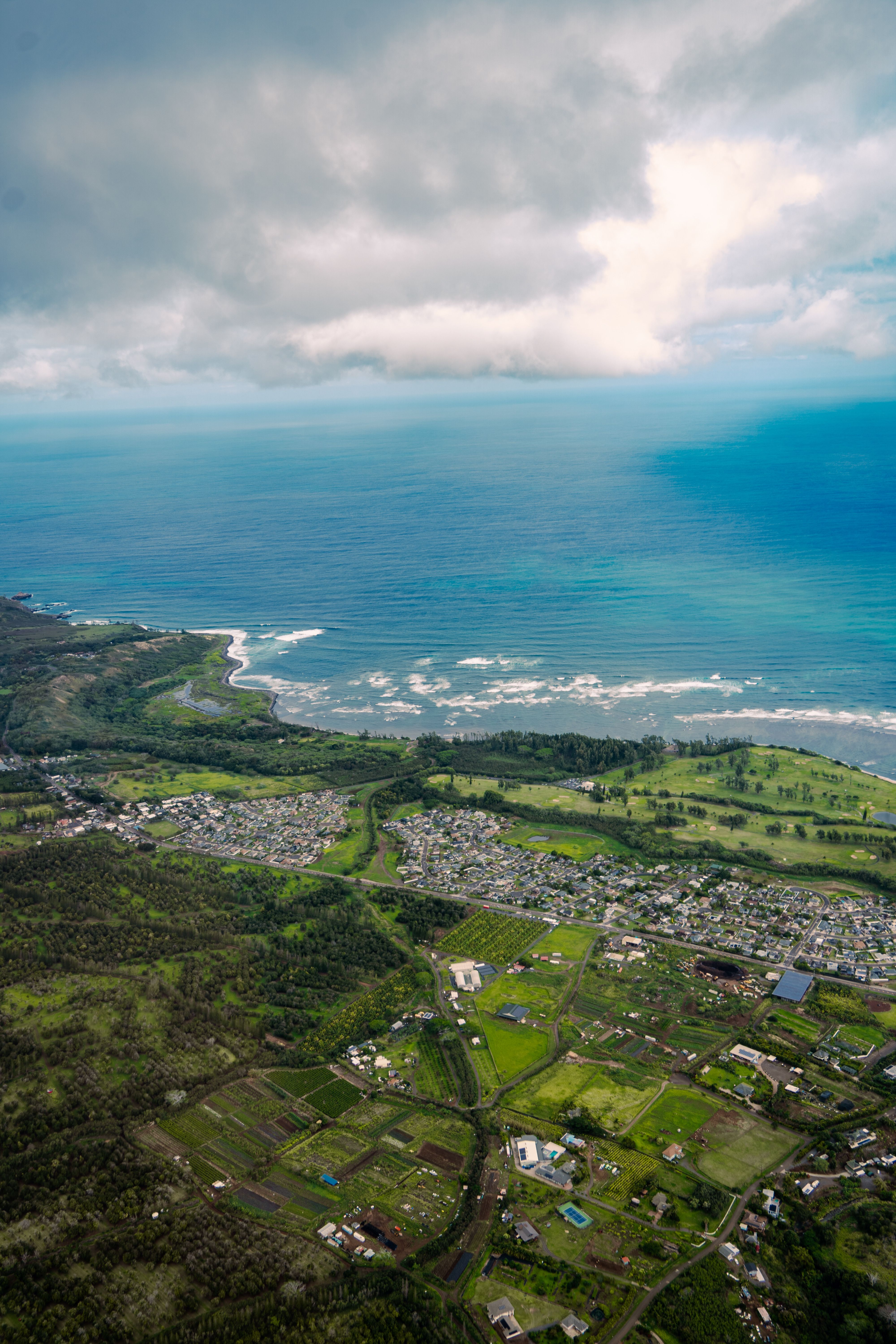 Aerial View of Coastal Town with Lush Greenery · Free Stock Photo