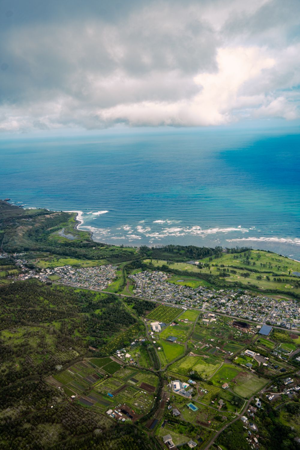 Aerial View of Coastal Town with Lush Greenery · Free Stock Photo