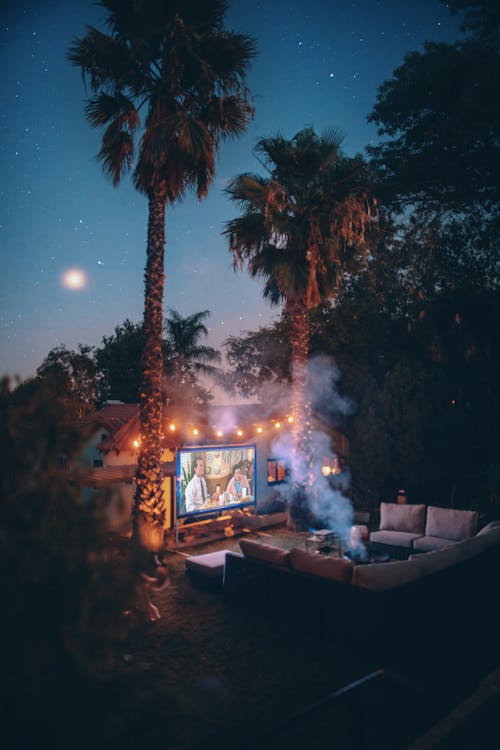 Free Palm Trees Near Projection Screen during Nighttime Stock Photo