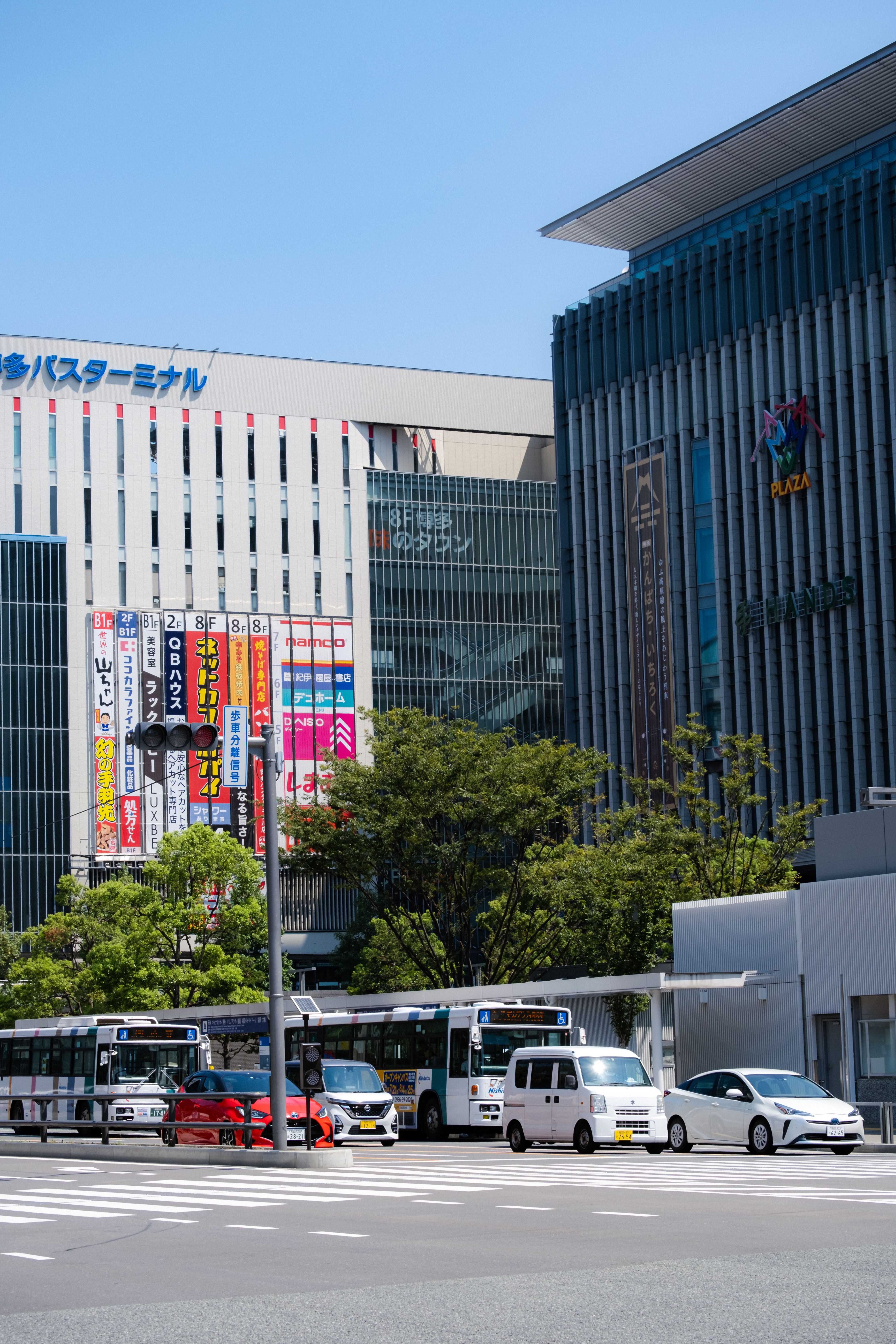 Street scene near Hakata Station in Fukuoka, Japan, with modern buildings and pedestrians